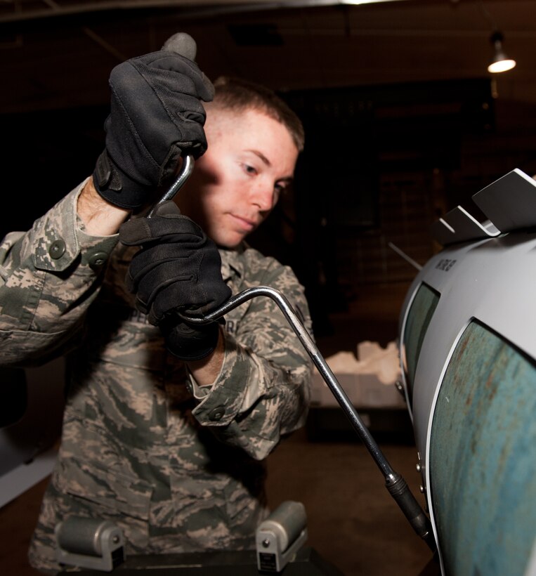 Airman 1st Class Benjamin Looper, 28th Munitions Squadron mission systems technician, secures strakes onto a Mark-84 inert bomb during training in the conventional maintenance shop at Ellsworth Air Force Base, S.D., Nov. 7, 2012. The squadron is responsible for 1,707 munitions line items worth $128 million, 577,000 pounds net explosive weight, 86 facilities and a 647-acre munitions storage area. (U.S. Air Force photo by Airman 1st Class Kate Thornton-Maurer/Released)