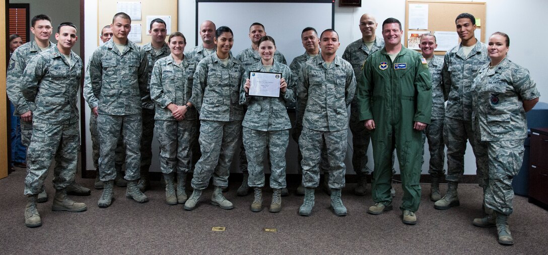 Members of Laughlin’s 47th Operations Support Squadron pose for a photo after receiving an award for being the top power producers in the “Sweat for Power” competition Nov. 13, 2012. The 47th OSS generated 900 watt-hours of power on five retrofitted elliptical machines at the Losano Fitness Center at Laughlin Air Force Base, Texas. The competition was one of the many activities the 47th Civil Engineer Squadron sponsored as part of Laughlin's 2012 Energy Action Month. (U.S. Air Force photo/Airman 1st Class Nathan Maysonet)