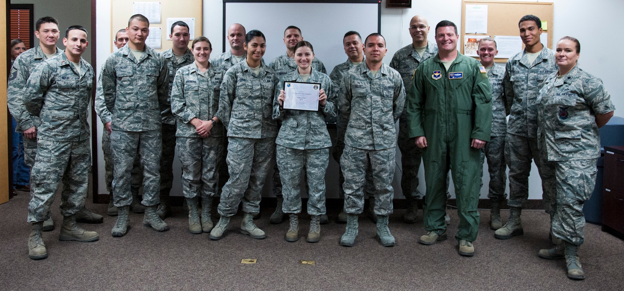 Members of Laughlin’s 47th Operations Support Squadron pose for a photo after receiving an award for being the top power producers in the “Sweat for Power” competition Nov. 13, 2012. The 47th OSS generated 900 watt-hours of power on five retrofitted elliptical machines at the Losano Fitness Center at Laughlin Air Force Base, Texas. The competition was one of the many activities the 47th Civil Engineer Squadron sponsored as part of Laughlin's 2012 Energy Action Month. (U.S. Air Force photo/Airman 1st Class Nathan Maysonet)