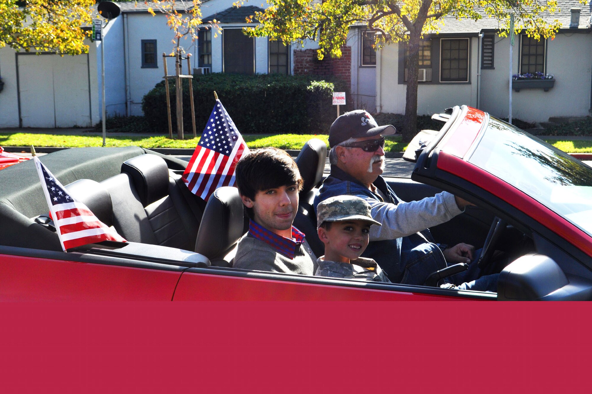 TRAVIS AIR FORCE BASE, Calif. -- TRAVIS AIR FORCE BASE, Calif. -- Travis Air Force Base turned out in force to support the local Solano County communities on Veterans Day Nov 11, 2012. At the Fairfield parade, riding in a red convertible were, left to right, Andrew and Jack Flournoy, sons of Brig. Gen. John C. Flournoy, Jr., Grand Marshal for this year's parade, and Commander of the Reserve's 349th Air Mobility Wing. Jack is also the Honorary Mayor of Fairfield, appointed by Mayor Harry Price. (U.S. Air Force photo/Senior Master Sgt. Ellen Hatfield) 