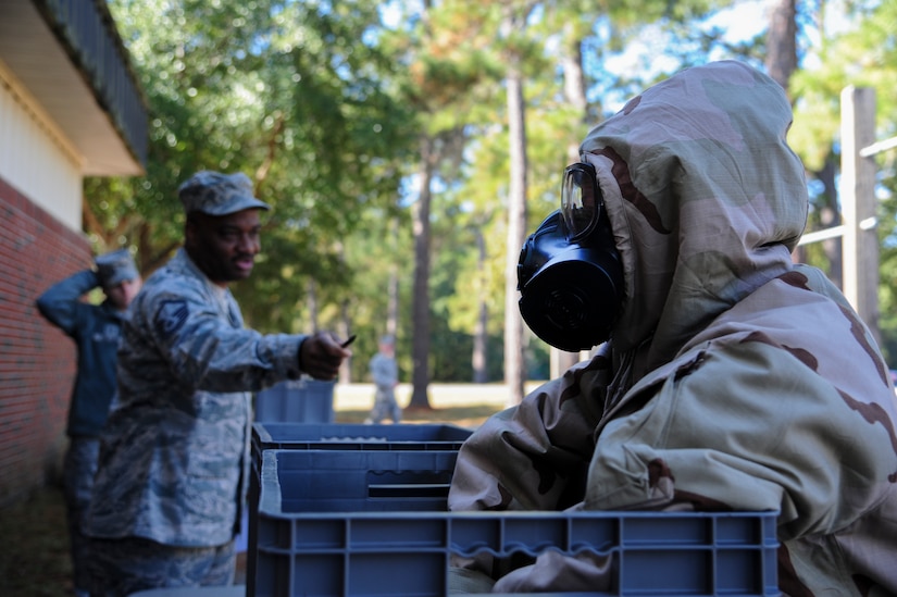 Master Sgt. Thomas Coney instructs Senior Airman Jaclyn McDonald on decontamination procedures during a Chemical, Biological, Radiological, Nuclear, Explosives Defense Survival Skills training scenario Nov. 8, 2012, at Joint Base Charleston - Air Base, S.C.  Coney and McDonald are combat photographers assigned to the 1st Combat Camera Squadron. 1st CTCS participates in various types of training to stay mission ready as they often document first responders in humanitarian relief efforts and disasters. (U.S. Air Force photo by/Staff Sgt. Rasheen Douglas)