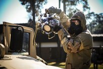 Staff Sgt. Robert Kingery, 1st Combat Camera Squadron combat videographer, simulates documenting a Chemical, Biological, Radiological, Nuclear, Explosives Defense Survival Skills training scenario Nov. 8, 2012, at Joint Base Charleston - Air Base, S.C.  1st CTCS participates in various types of training to stay mission ready as they often document first responders in humanitarian relief efforts and disasters. (U.S. Air Force photo by/Staff Sgt. Rasheen Douglas)