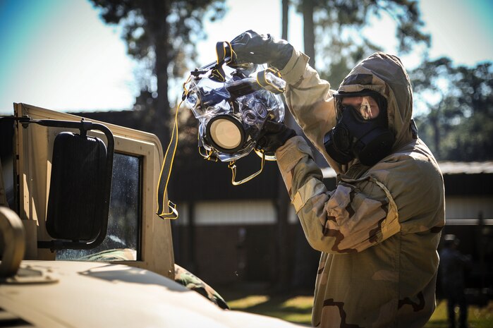 Staff Sgt. Robert Kingery, 1st Combat Camera Squadron combat videographer, simulates documenting a Chemical, Biological, Radiological, Nuclear, Explosives Defense Survival Skills training scenario Nov. 8, 2012, at Joint Base Charleston - Air Base, S.C.  1st CTCS participates in various types of training to stay mission ready as they often document first responders in humanitarian relief efforts and disasters. (U.S. Air Force photo by/Staff Sgt. Rasheen Douglas)