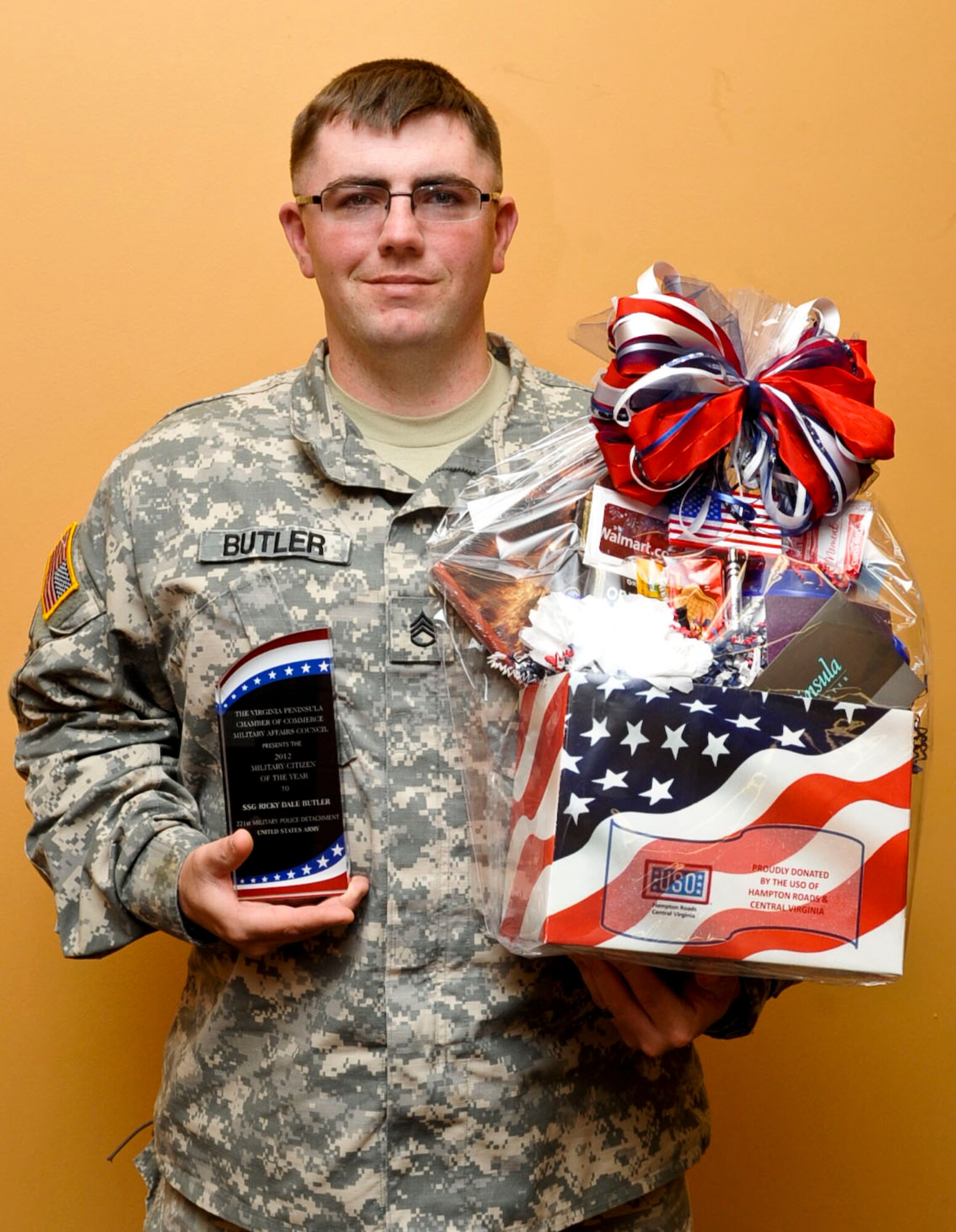 U.S. Army Staff Sgt. Ricky Dale Butler, 221st Military Police Detachment noncommissioned officer in charge of training, holds his Military Citizen of the Year award at Fort Eustis, Va., Nov. 14, 2012. Butler received the award for going above and beyond in his duties and creating strong ties with the local community. (U.S. Air Force photo by Staff Sgt. Wesley Farnsworth/Released)