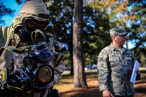 Staff Sgt. Robert Kingery, 1st Combat Camera Squadron combat videographer, simulates documenting a Chemical, Biological, Radiological, Nuclear, Explosives Defense Survival Skills training scenario Nov. 8, 2012, at Joint Base Charleston - Air Base, S.C.  1st CTCS participates in various types of training to stay mission ready as they often document first responders in humanitarian relief efforts and disasters. (U.S. Air Force photo/Staff Sgt. Rasheen Douglas)