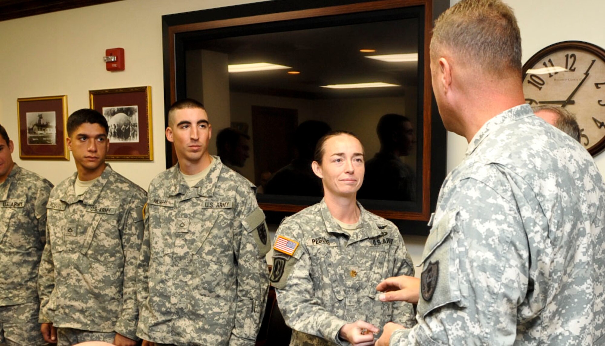 Col. Thomas Wetherington, 733rd Mission Support Group commander, presents commander's coins to members of the Fort Eustis Army Ten-Miler running team at the 733rd MSG headquarters building at Fort Eustis, Va., Nov. 13, 2012. Wetherington congratulated the Soldiers for their performance at the race in October, praising them as outstanding representatives of the installation and the Army as a whole. (U.S. Air Force photo by Staff. Sgt. Wesley Farnsworth/Released)