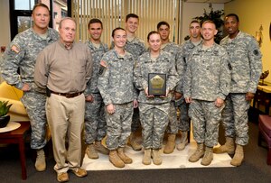 Members of the Fort Eustis Army Ten-Miler running team pose for a photo with Col. Thomas Wetherington, 733rd Mission Support Group commander, and Sgt. Maj. Jesse Sharpe, 733rd MSG command sergeant major, at the 733rd MSG headquarters building on Fort Eustis, Va., Nov. 13, 2012. The team finished third place out of 79 teams in Active Duty Military Mixed division at the race, which took place Oct. 21 in Washington, D.C. (U.S. Air Force photo by Staff. Sgt. Wesley Farnsworth/Released)