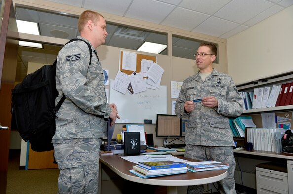 Master Sgt. Eric Bollmann, right, operations superintendent for the Paul H. Lankford Enlisted Professional Military Education Center, helps a new member of the I.G. Brown Training and Education Center process into the unit at McGhee-Tyson Air National Guard Base, Tenn., Nov. 14. Bollmann was recently recognized by the East Tennessee Military Affairs Council as an outstanding enlisted service member during the 30th Annual Veteran’s Day Awards and Recognition Luncheon. (Air Force photo by Master Sgt. Kurt Skoglund)