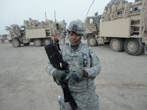 During a Joint-base Balad Chaplain Unit ministry tour “Operation New Dawn.” Sgt. LaRita Fullwood, 7th Sustainment Brigade chaplain assistant noncommissioned officer in charge, stands outside a convoy with her M-16 at the Ziggurat in Ur, Iraq. This was the unit’s last tour prior to base closure. (U.S. Army courtesy photo/Released)