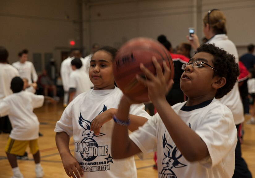 Marcus Pearson, son of Tech. Sgt. Marcus Pearson,628th Logistics Readiness Squadron, practices shooting during a Hoops from Home Clinic Nov. 8, 2012, at Joint Base Charleston - Air Base, S.C. Hoops from Home is a non-profit organization providing a basketball camp/clinic experience to the children of military families across the world. It provides the children with an opportunity to work with players and coaches and highlight the benefits of team sports, physical activity and commitment. (U.S. Air Force photo/Airman 1st Class Ashlee Galloway)