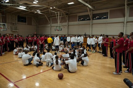 Basketball players from Ohio State, Notre Dame and Marquette University gather with military children after a Hoops from Home clinic Nov. 8, 2012, at Joint Base Charleston, S.C. Hoops from Home is a non-profit organization providing a basketball camp/clinic experience to children of military families across the world. It provides the children with an opportunity to work with players and coaches and highlight the benefits of team sports, physical activity and commitment. (U.S. Air Force photo/Airman 1st Class Ashlee Galloway)