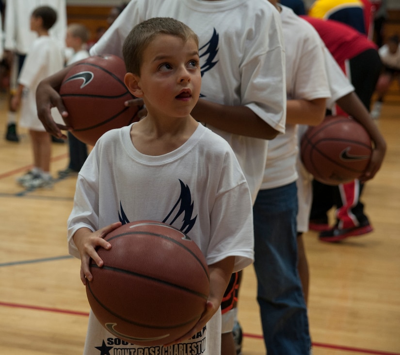 Nicholas Bandy, son of Staff Sgt. Stephanie Bandy, 628th Logistics Readiness Squadron, prepares to take a shot during a Hoops from Home Clinic Nov. 8, 2012, at Joint Base Charleston, S.C. Hoops from Home is a non-profit organization providing a basketball camp/clinic experience to children of military families across the world. It provides the children with an opportunity to work with players and coaches and highlight the benefits of team sports, physical activity and commitment. (U.S. Air Force photo/Airman 1st Class Ashlee Galloway)