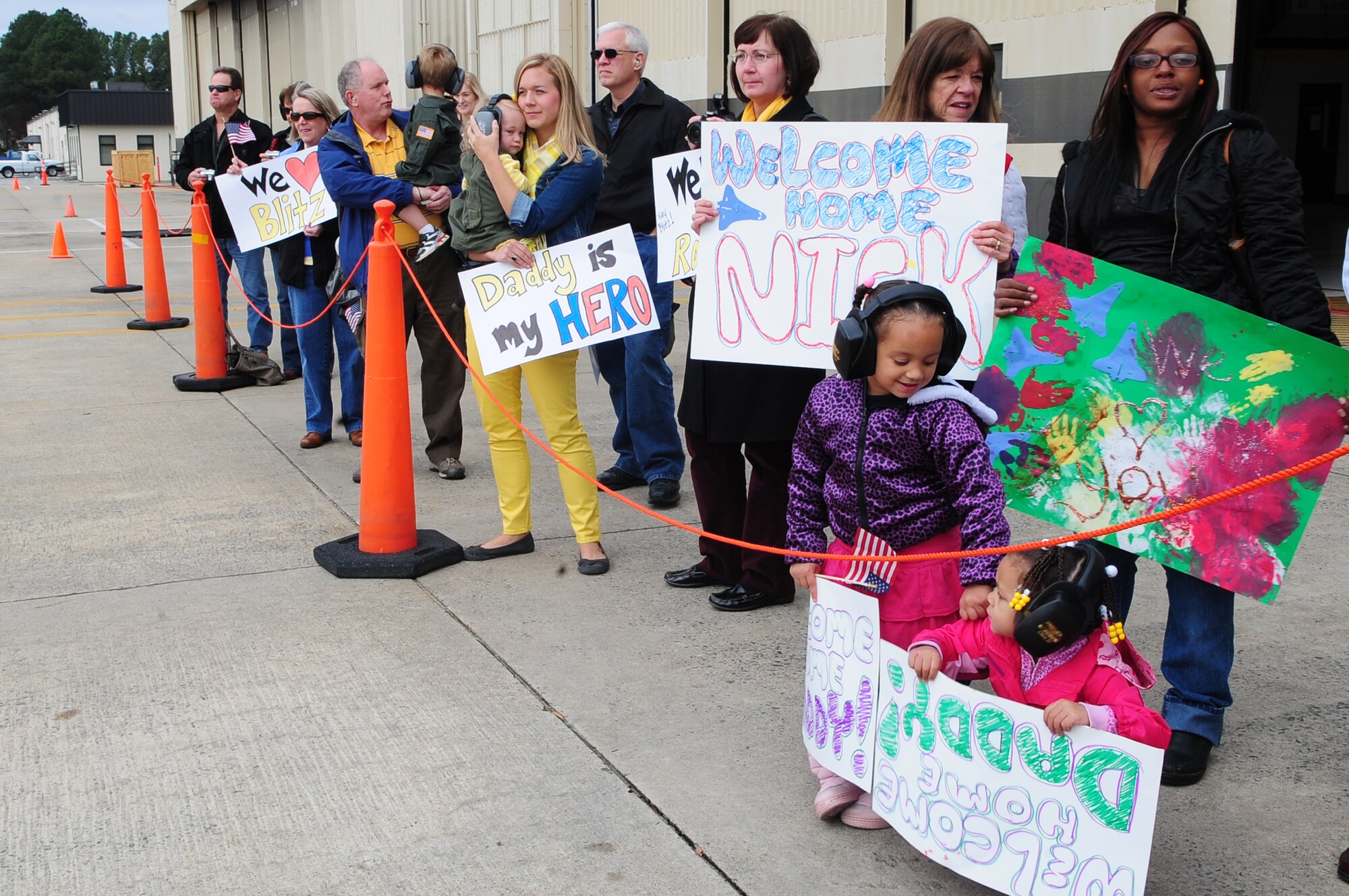 Members of Team Seymour await the arrival of loved ones at a deployment return on Seymour Johnson Air Force Base, N.C., Nov. 14, 2012. Families, friends and fellow U.S. Air Force Airmen welcomed home aircrew members after a six-month deployment to Middle East. (U.S. Air Force photo/Airman 1st Class Aubrey White/Released)