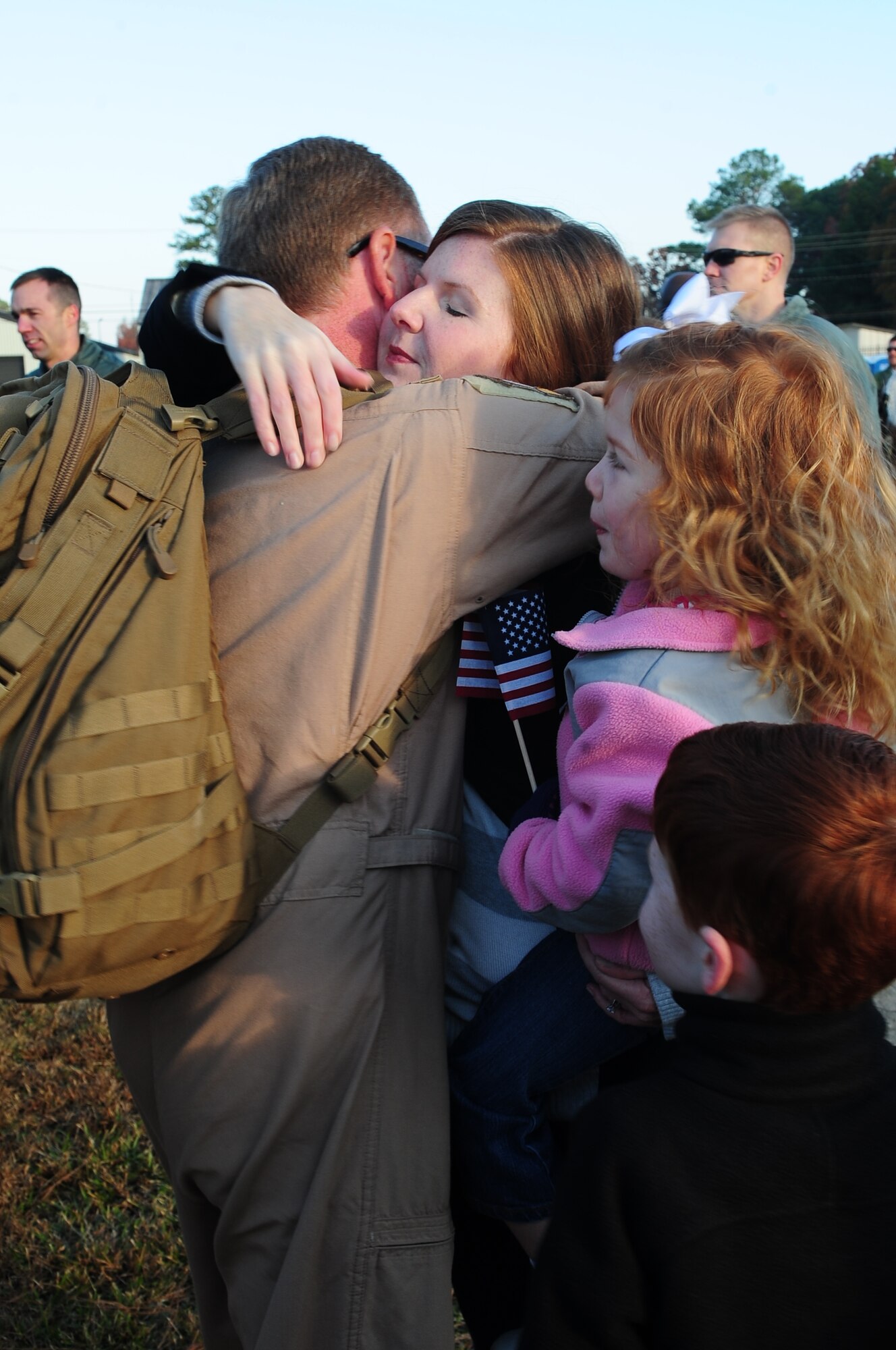 U.S. Air Force Capt. Philip Gunn, 336th Fighter Squadron pilot, embraces his family at a deployment return on Seymour Johnson Air Force Base, N.C., Nov. 14, 2012. Gunn, along with approximately 150 other Airmen, were deployed for six months to the Middle East. (U.S. Air Force photo/Airman 1st Class Aubrey White/Released)