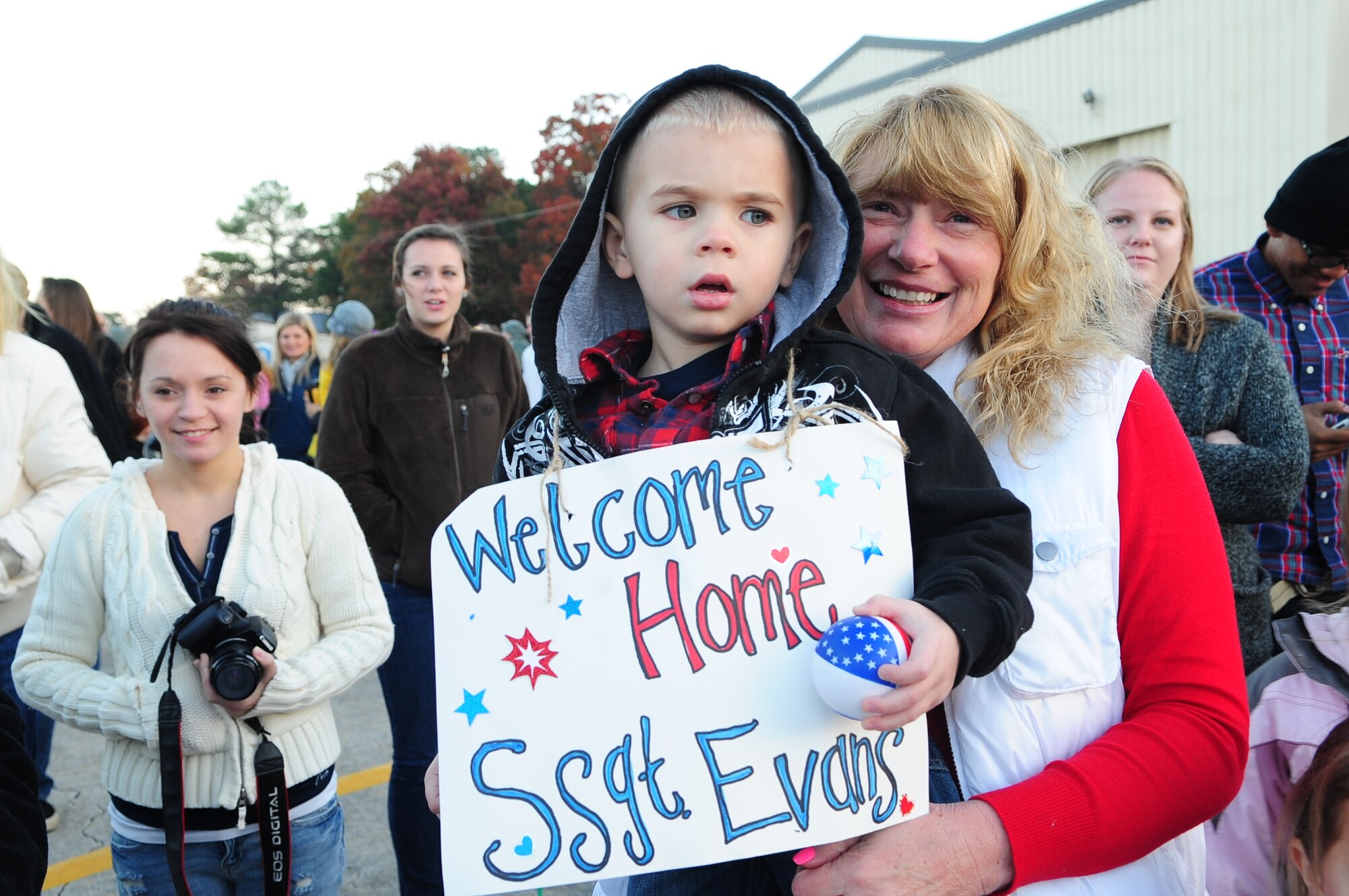 The Evans family awaits the arrival of U.S. Air Force Staff Sgt. Jonathan Evans, 4th Equipment Maintenance Squadron, at a deployment return on Seymour Johnson Air Force Base, N.C., Nov. 14, 2012. The family drove from New York and arrived in time to see Evans return. (U.S. Air Force photo/Airman 1st Class Aubrey White/Released)