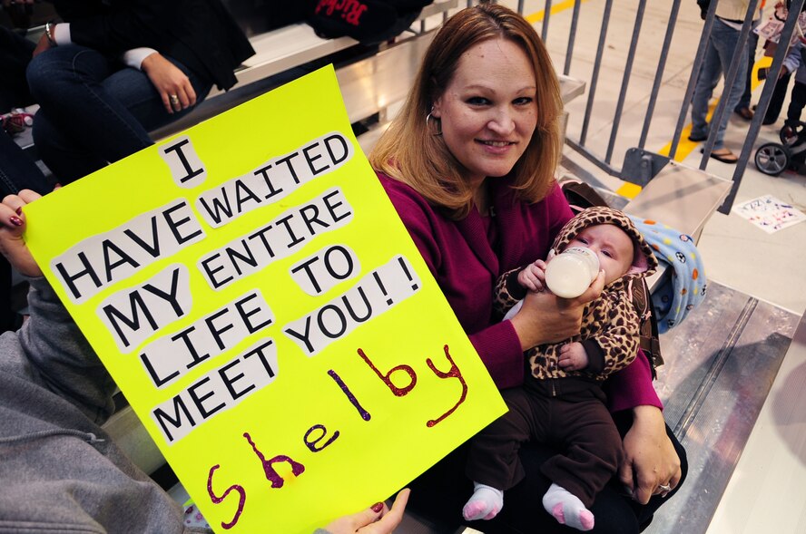 Torina Prechtel, spouse of U.S. Air Force Tech. Sgt. Matthew Prechtel, 4th Equipment Maintenance Squadron, feeds her daughter, Shelby, 2 months, as they await Evans’ arrival at a deployment return on Seymour Johnson Air Force Base, N.C., Nov. 14, 2012. Through the use of mobile video-chat, Prechtel was able to watch Shelby’s birth while deployed to the Middle East. (U.S. Air Force photo/Airman 1st Class Aubrey White/Released)