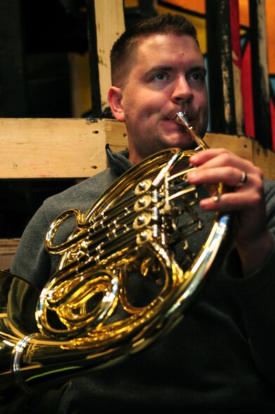 U.S. Air Force Airman 1st Class Dan Omer, U.S. Air Force Heritage of America Band French hornist, plays a French horn in preparation for a performance at Jesse Carson High School in China Grove, N.C., Nov. 9, 2012. Omer has played the horn for more than 20 years, and is a native of Utah. (U.S. Air Force photo/Airman 1st Class Aubrey White/Released)