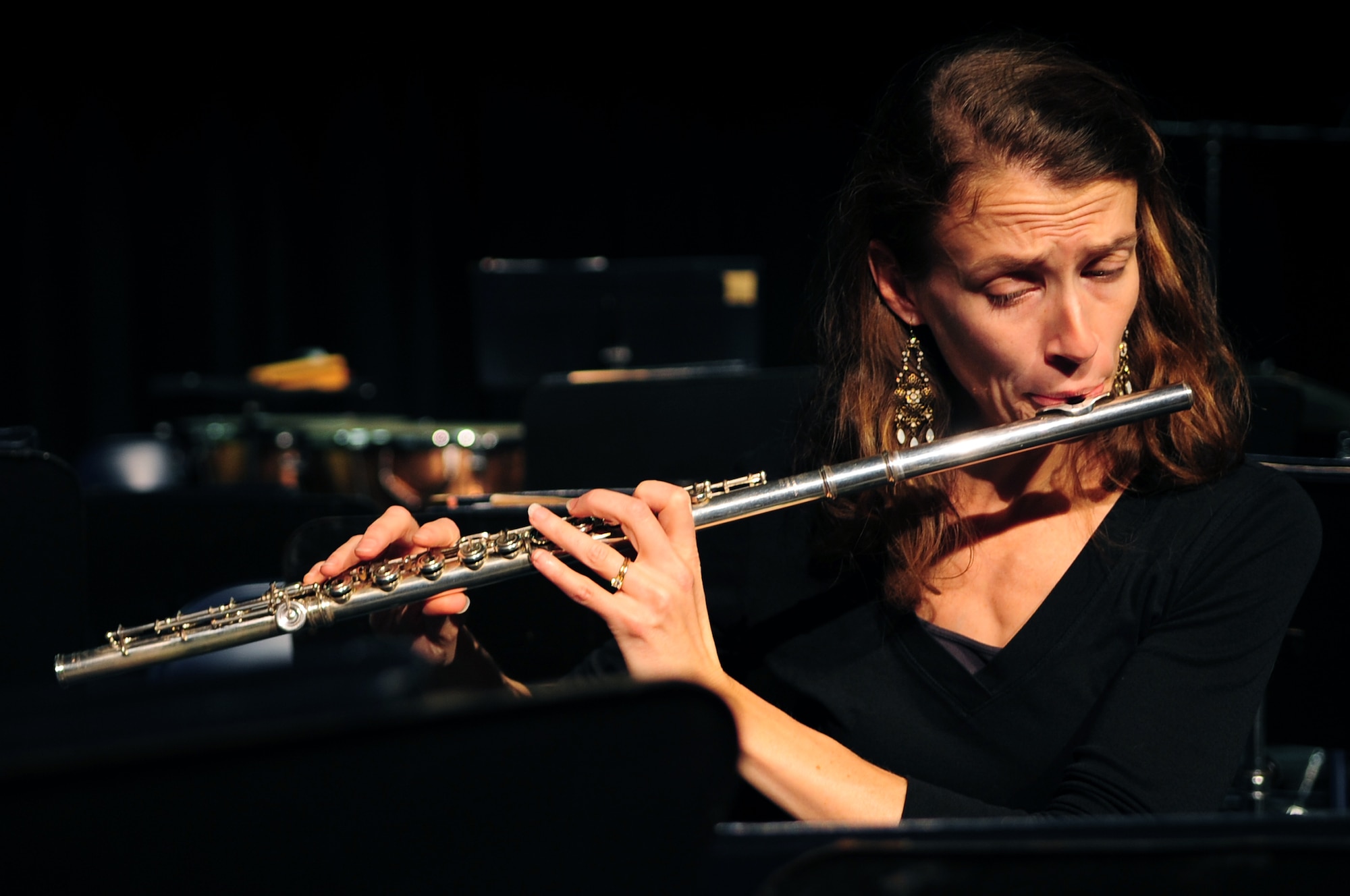 UU.S. Air Force Tech. Sgt. Anne Epperly, U.S. Air Force Heritage of America Band flutist and piccoloist, plays the flute during a sound check prior to the band’s performance at Jesse Carson High School in China Grove, N.C., Nov. 9, 2012. The band’s mission is to reach out to communities and tell the Air Force story through the use of wind, brass and percussion instruments. Epperly is a native of Virginia. (U.S. Air Force photo/Airman 1st Class Aubrey White/Released)