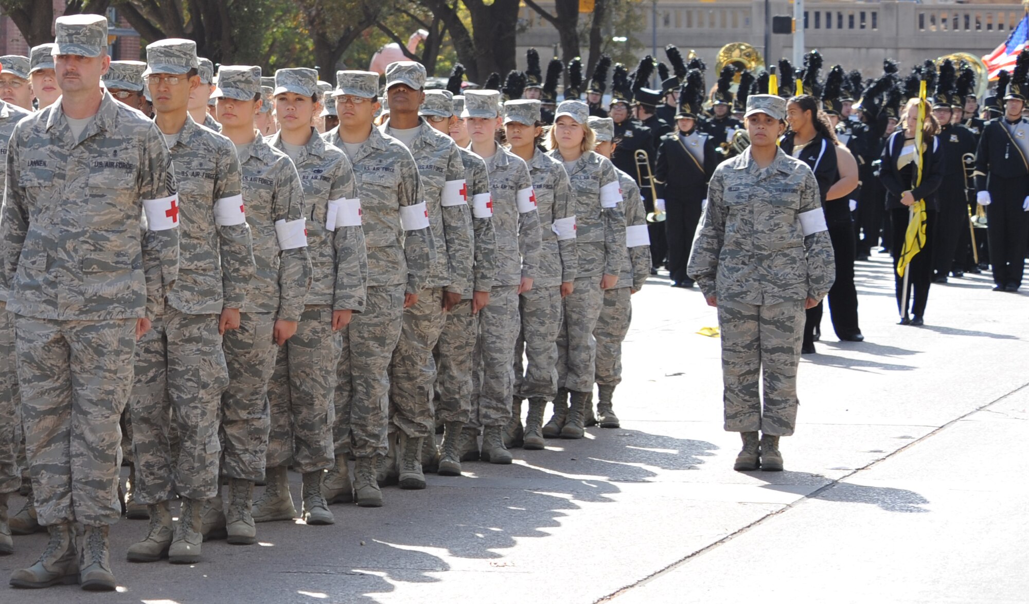 Airmen from the 7th Medical Group stand at attention during the national anthem at the Abilene Veterans Day Parade Nov. 10, 2012, in Abilene, Texas. Dyess Air Force Base Airmen marched alongside local Junior Reserve Officers’ Training Corps cadets and marching bands in Abilene's annual parade to commemorate the service military members provide to the United States. (U.S. Air Force photo by Airman 1st Class Peter Thompson/ Released)