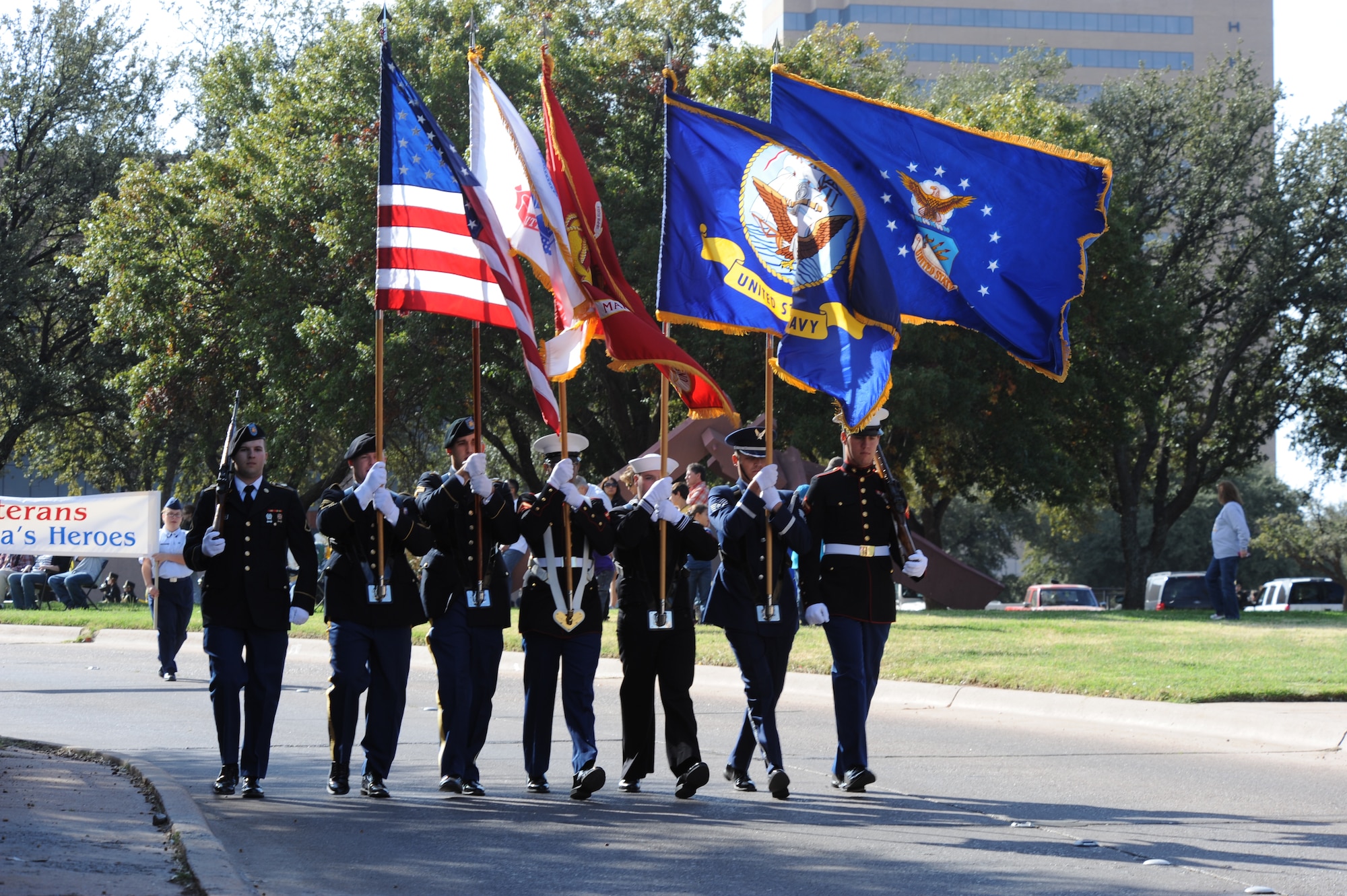 The color guard leads the Abilene Veterans Day parade Nov. 10, 2012, in Abilene, Texas. Dyess Air Force Base Airmen marched alongside local Junior Reserve Officers’ Training Corps cadets and marching bands in Abilene's annual parade to commemorate the service military members provide to the United States. (U.S. Air Force photo by Airman 1st Class Peter Thompson/ Released) 