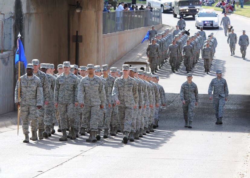 Airmen from the 7th Bomb Wing march through downtown Abilene during the Abilene Veterans Day Parade Nov. 10, 2012, in Abilene, Texas. Dyess Air Force Base Airmen marched alongside local Junior Reserve Officers’ Training Corps cadets and marching bands in Abilene's annual parade to commemorate the service military members provide to the United States. (U.S. Air Force photo by Airman 1st Class Peter Thompson/ Released)