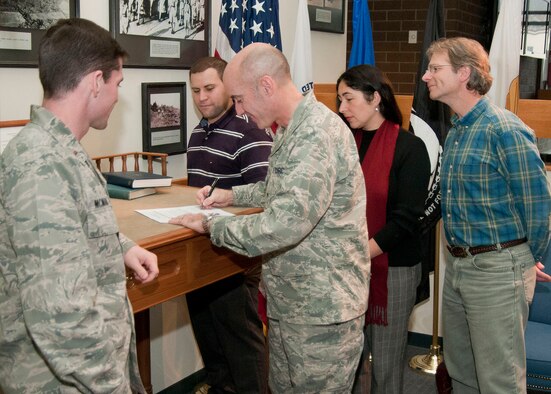 HANSCOM AIR FORCE BASE, Mass. -- Col. Lester A. Weilacher, 66th Air Base Group commander, signs a proclamation Nov. 8 in the atrium of Building 1305 that recognizes November as Native American Heritage Month at Hanscom Air Force Base as committee members look on. NAHM committee members include (left to right) 2nd Lt. Daryl McMahan, Josh Hurst, Joann Schmidt and Lance Beebe. (U.S. Air Force photo by Mark Wyatt)