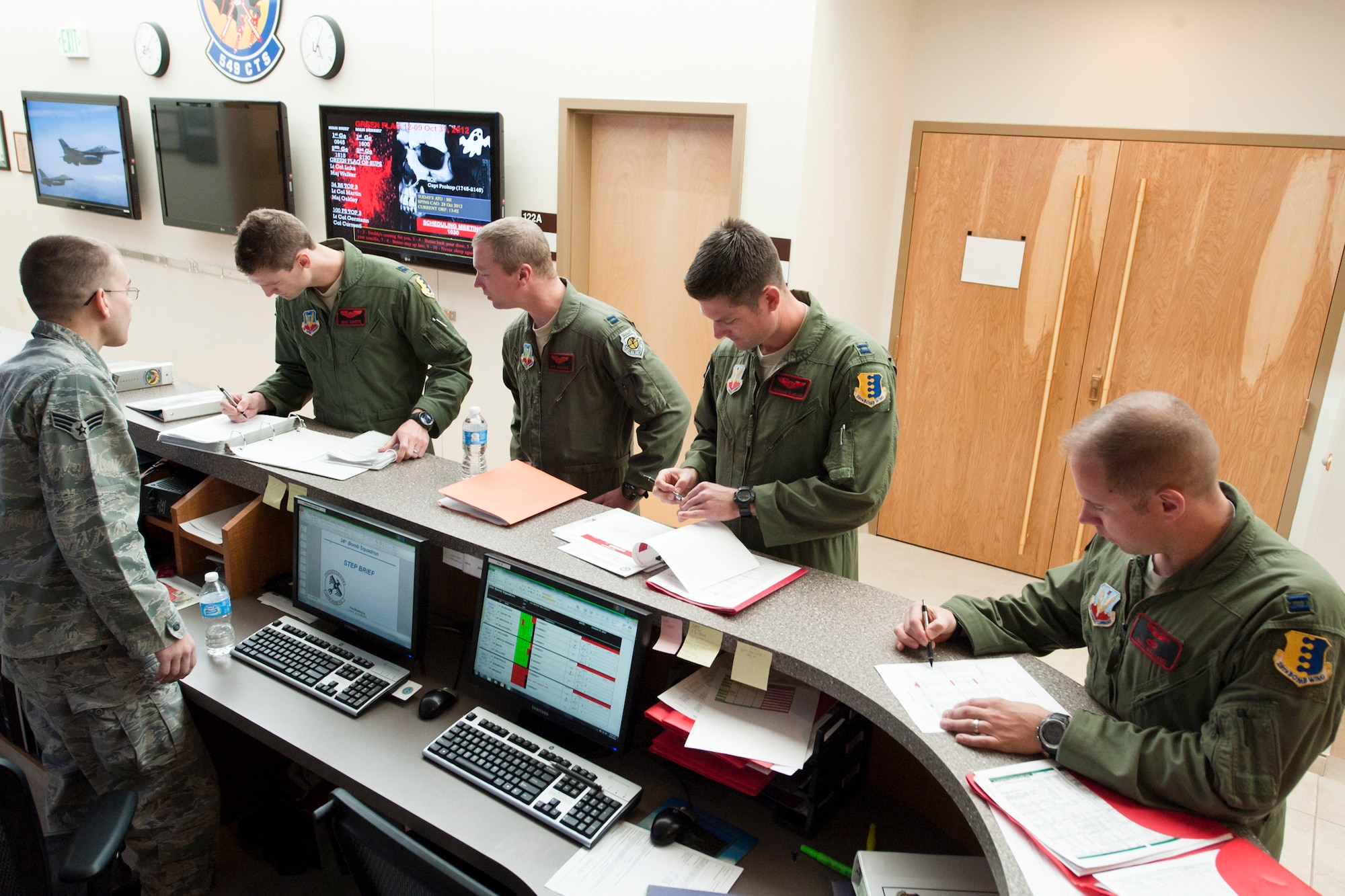 U.S. Air Force B-1B Lancer aircrew members from the 28th Bomb Wing, Ellsworth Air Force Base, S.D., review flight plans at the Green Flag operations desk prior to an training mission Oct. 31, 2012, at Nellis AFB, Nev. Green Flag-West 13-2 is a realistic air-land integration combat training exercise held at U.S. Army Combat Training Center at Fort Irwin, Calif., includes 3,000 flights and the expenditure of more than 700,000 pounds of live and training ordnance. (U.S. Air Force photo by Lawrence Crespo)
