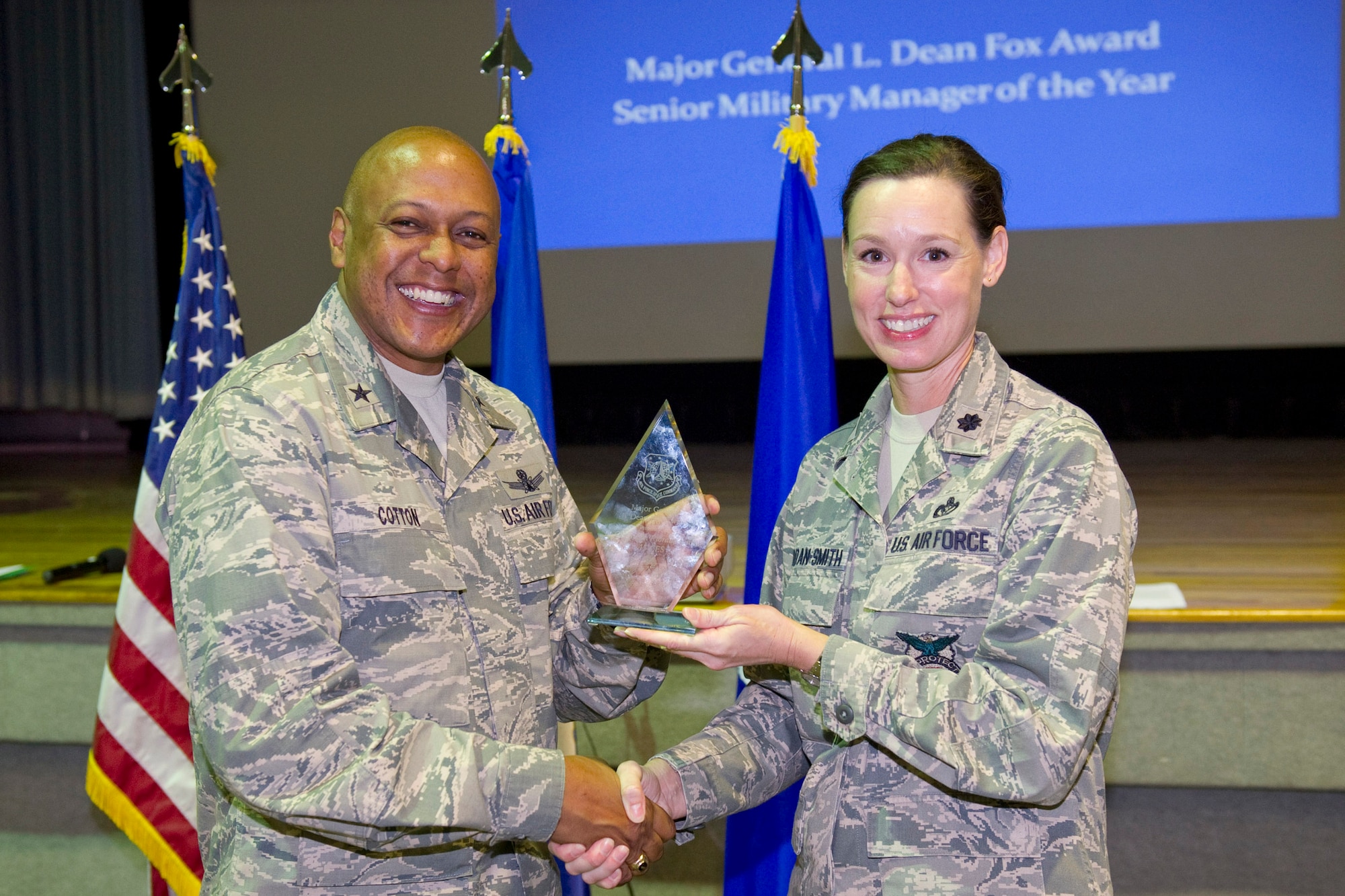 Brig. Gen. Anthony Cotton, commander, 45th Space Wing, presents the Major General L. Dean Fox Award, Senior Military Manager Category to Lt. Col. Susan Riordan-Smith, commander, 45th Civil Engineer Squadron. 