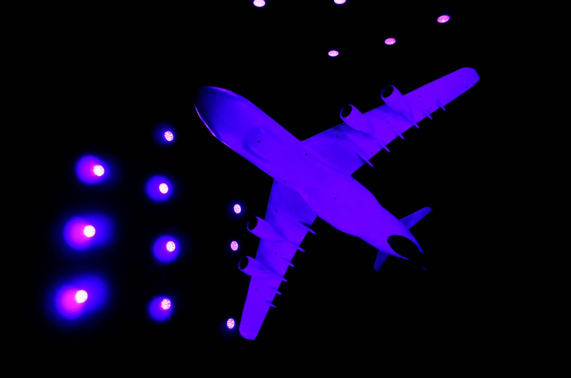 Pictured here is the C-5M Super Galaxy model during a break in testing in Arnold Engineering Development Complex’s (AEDC) 16-foot Transonic Wind Tunnel (16T). The model’s coloring is a result of the purple LEDs used to illuminate the Pressure Sensitive Paint (PSP). (Photo by Rick Goodfriend)