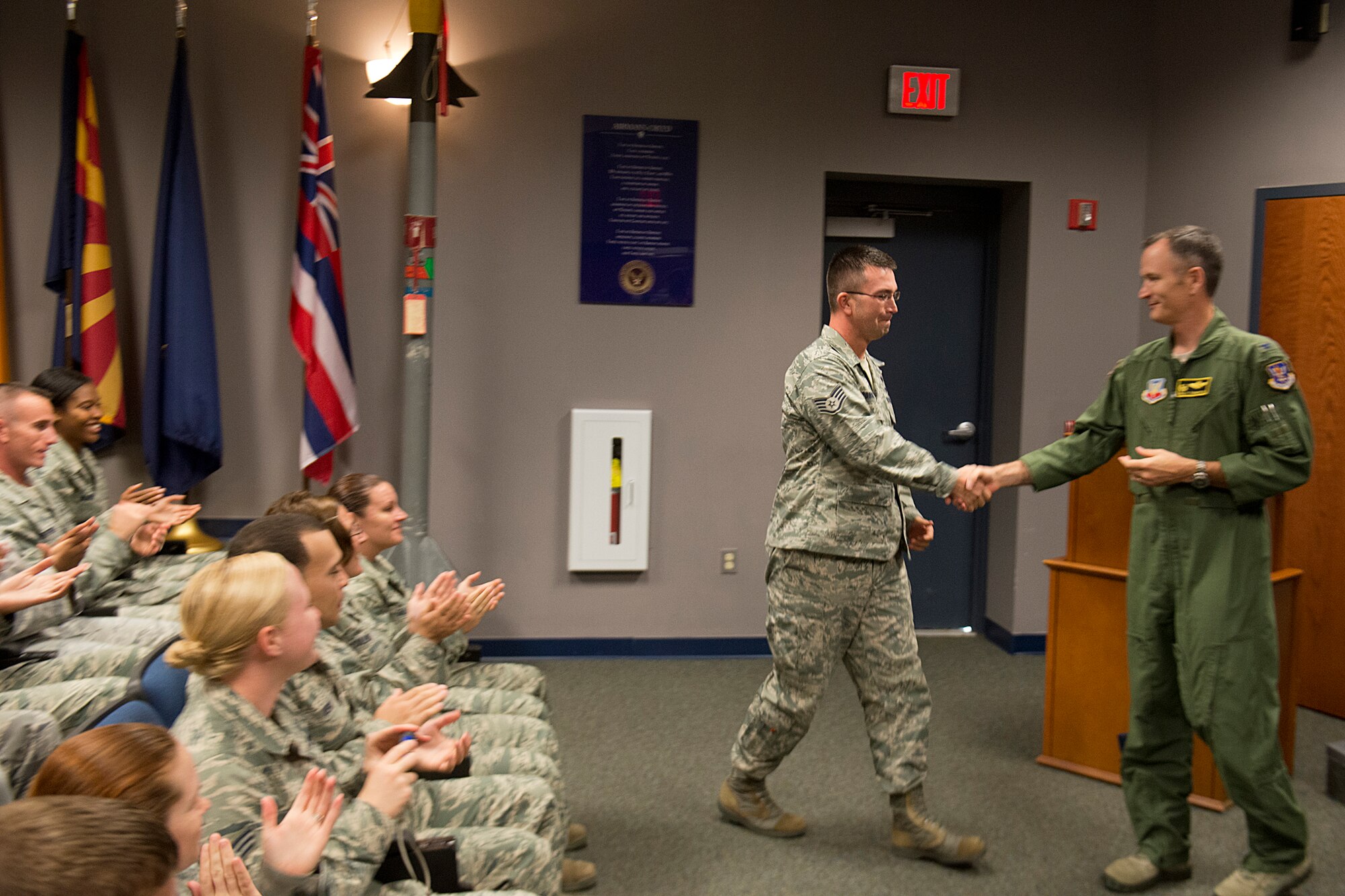 U.S. Air Force Staff Sgt. Michael Youngblood, 23d Force Support Squadron Senior Airman Jason D. Cunningham Airman Leadership School instructor, shakes hands with Col. Billy Thompson, 23d Wing commander, after being notified of his promotion to technical sergeant Nov. 14, 2012, at Moody Air Force Base, Ga. Youngblood was promoted under the Stripes for Exceptional Performers program. (U.S. Air Force photo by Staff Sgt. Jamal D. Sutter/Released) 
