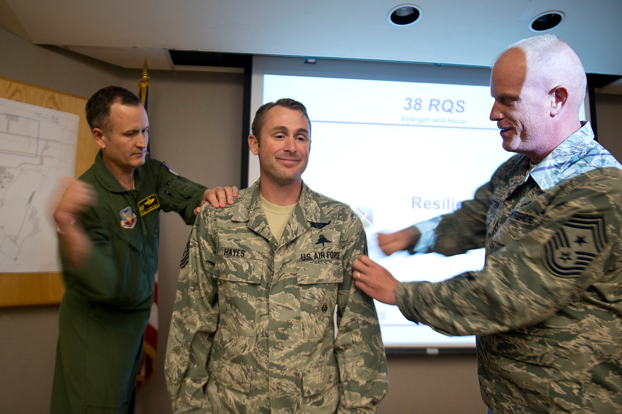 U.S. Air Force Tech. Sgt. Duane Hayes, 38th Rescue Squadron standards and evaluations NCO in charge, receives his master sergeant stripes from Col. Billy Thompson, 23d Wing commander, and Chief Master Sgt. Frank Batten, 23d WG command chief, during a surprise promotion under the Stripes for Exceptional Performers program Nov. 13, 2012, at Moody Air Force Base, Ga. Hayes was prepared to conduct resilience training when Thompson and Batten stopped by to drop the news. (U.S. Air Force photo by Staff Sgt. Jamal D. Sutter/Released) 