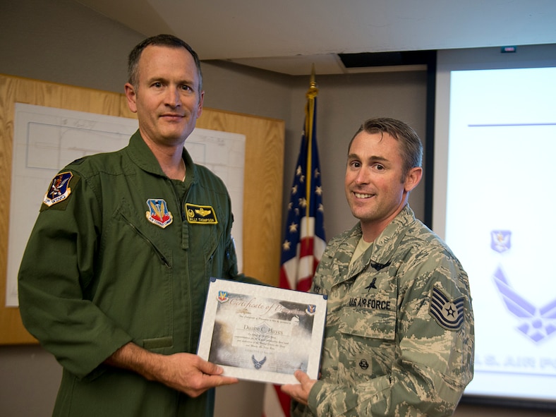 U.S. Air Force Tech. Sgt. Duane Hayes, 38th Rescue Squadron standards and evaluations NCO in charge, receives a promotion certificate from Col. Billy Thompson, 23d Wing commander, Nov. 13, 2012, at Moody Air Force Base, Ga. Hayes was promoted to master sergeant under the Stripes for Exceptional Performers program. (U.S. Air Force photo by Staff Sgt. Jamal D. Sutter/Released) 