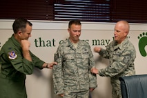 U.S. Air Force Staff Sgt. Cody Murray, 23d Maintenance Group HH-60 quality assurance inspector, receives technical sergeant stripes from Col. Billy Thompson, 23d Wing commander, and Chief Master Sgt. Frank Batten, 23d WG command chief, during a surprise promotion under the Stripes for Exceptional Performers program Nov. 13, 2012, at Moody Air Force Base, Ga. Murray did not feel well that morning and wasn’t going to make it to his unit’s staff meeting, but when he received grief from his leadership for not being there, he showed up to be notified of his new rank. (U.S. Air Force photo by Staff Sgt. Jamal D. Sutter/Released)
