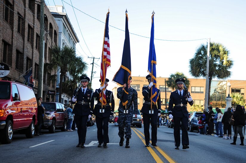 Members of the Joint Base Charleston Honor Guard march in the Veterans Day Parade Nov. 10, 2012, in Charleston, S.C. More than a hundred Airmen and Sailors from JB Charleston marched in the parade, which traveled through the streets of historic downtown Charleston. The parade kicked off with the playing of the National Anthem and a fly-over by a JB Charleston C-17 Globemaster III.  The parade was sponsored by the Ralph H. Johnson VA Medical Center and featured historic military vehicles, motorcycle groups and veterans’ service organization floats. (U.S. Air Force photo/Staff Sgt. Rasheen Douglas)