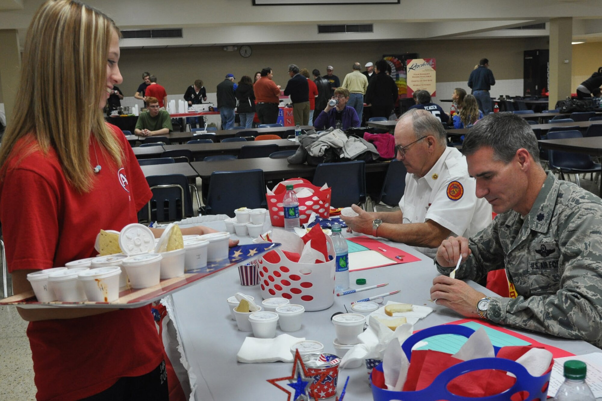 An Austintown Fitch High School junior serves chili to Air Force Reserve Lt. Col. Dan Sarachene, commander of the 757th Airlift Squadron based at Youngstown air Reserve Station Nov. 12, 2012. Sarachene volunteered to be one of several judges at Fitch’s premier chili contest. Proceeds from the event will benefit several Austintown school bands as well as the Youngstown VA Food Pantry. Released/U.S. Air Force photo by Maj. Brent J. Davis