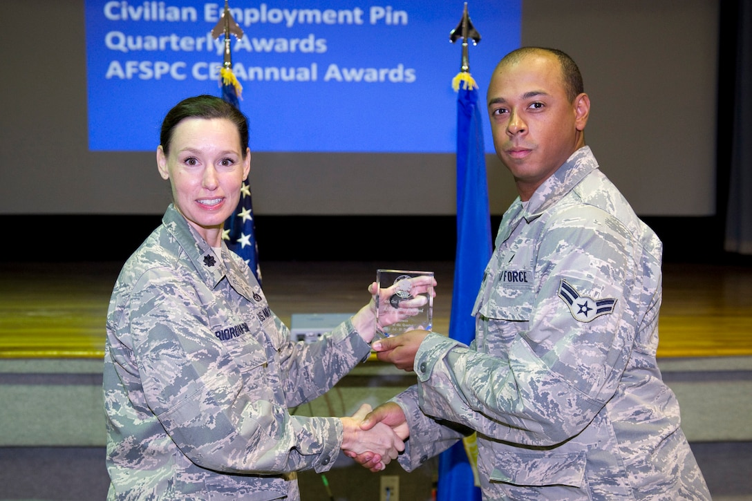 Lt. Col. Susan Riordan-Smith, commander, 45th Civil Engineer Squadron, presents the Airman of the Quarter Award to Airman 1st Class Bradley Haywood.