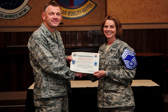 Col. Richard McComb, Joint Base Charleston commander, presents a certificate of promotion to Senior Master Sgt. Jan Menard, 628th Aerospace Medicine  Squadron bioenvironmental engineering flight chief, at the Charleston Club Nov. 9, 2012, on Joint Base Charleston – Air Base, S.C. The Air Force released the list of 454 senior master sergeants selected for promotion to chief master sergeant. The new E-9s were selected by an evaluation board that met in October and will join the ranks of less than one percent of the service’s enlisted force. The senior noncommissioned officers who made the cut this year were selected from a pool of 1,981 eligible senior master sergeants. (U.S. Air Force photo/Staff Sgt. Rasheen Douglas)