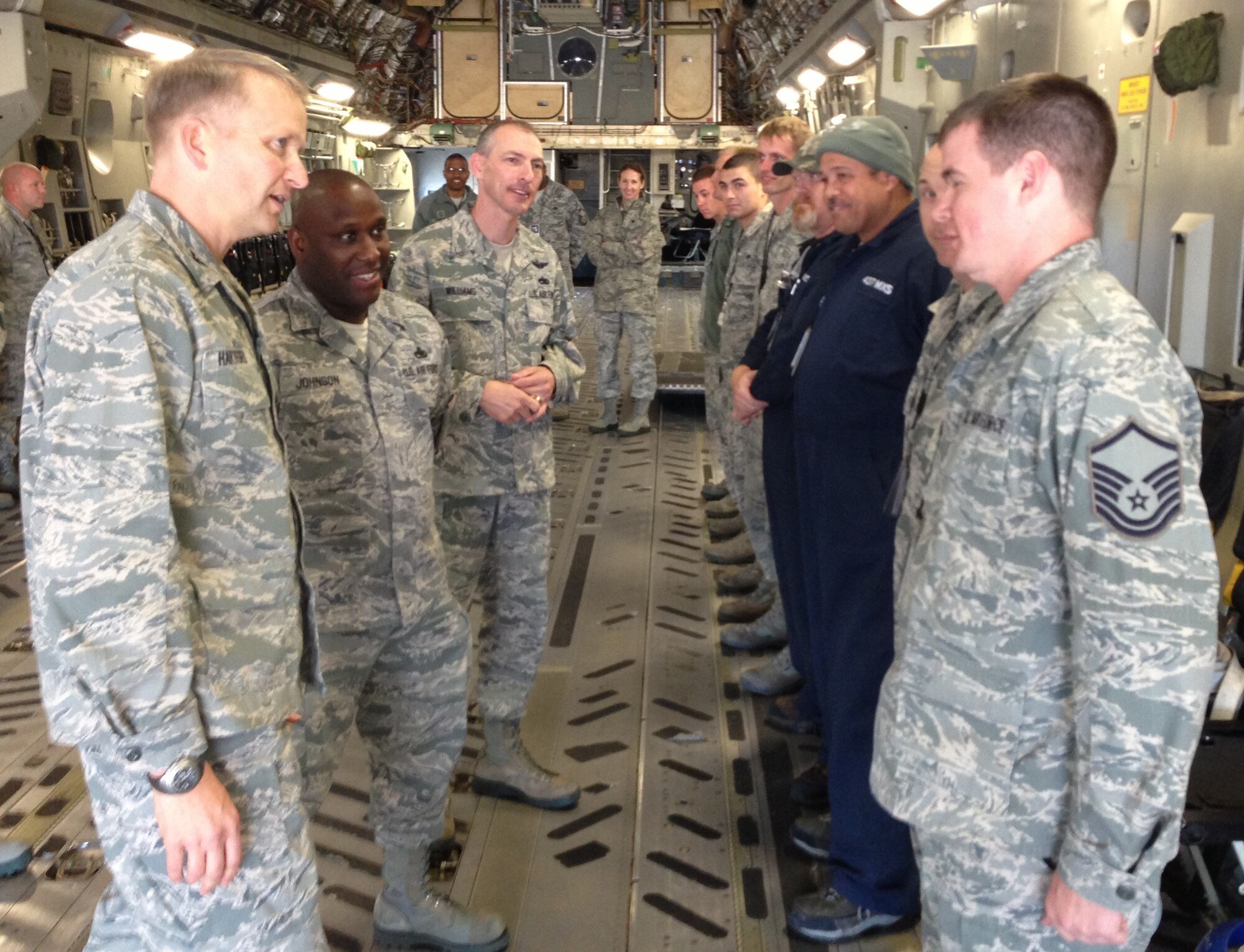 Col. Darren Hartford, 437th Airlift Wing commander, and Chief Master Sgt. Larry Williams (third from left) recognize a group of 20 maintainers from the 437th Aircraft Maintenance Squadron, 437th Maintenance Squadron and Boeing engineers inside a C-17 Nov. 7, 2012, at Joint Base Charleston – Air Base, S.C. Hartford congratulated several members of the group with command coins. The maintenance team, led by Master Sgt. Charles Johnson of the 437th AMXS (second from left), showed outstanding dedication and perseverance and spent more than 600 man hours repairing a C-17 with an extensive history of cargo door pressurization problems. Hartford specifically addressed the group’s excellent work ethic, immaculate attention to detail and exceptional team work with the Boeing Company since the arrival of the first C-17.  (U.S. Air Force photo/Lt. Col. Ryan White)