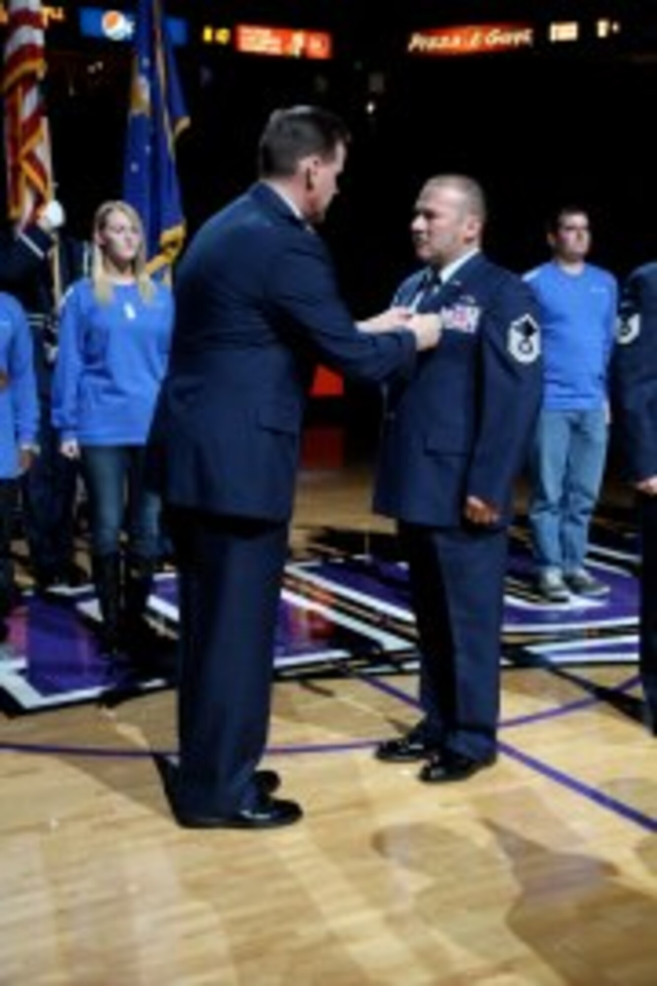 Col. Kevin Cavanagh, 940th Wing commander, presents Master. Sgt. Pedro Villa with the Purple Heart Medal for his actions in Operation Enduring Freedom at the Sacramento Kings military appreciation game in Sacramento, Calif., Nov 9, 2012. The Kings held a military appreciation night in honor of Veterans Day. (U.S. Air Force photo by Tech Sgt. Kenneth McCann/Released)
