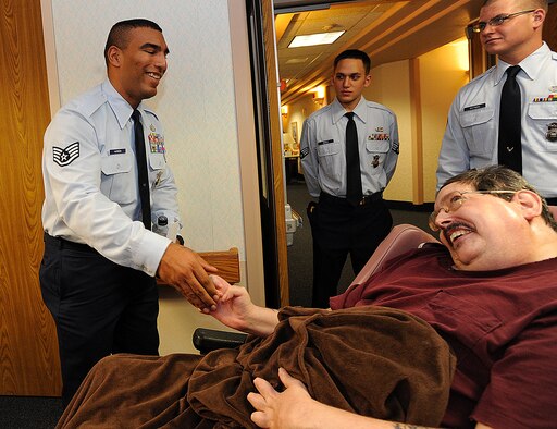 MINOT, N.D. -- Staff Sgt.  Anthony Harmon, 791st MSFS support flight chief, greets a local veteran at the Minot Trinity Homes following a ceremony, Nov. 9. 791st MSFS personnel have had a long standing community relationship with the elderly community in Trinity Homes. (U.S. Air Force photo/Senior Airman Jose L. Hernandez)