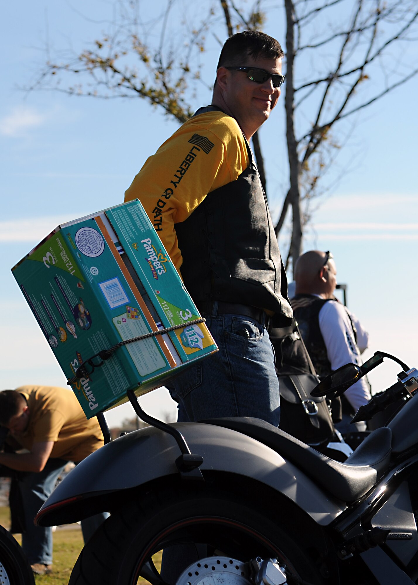Maj. Peter Lex, 19th Security Forces Squadron commander and a member of the Green Knights motorcycle club, waits to unload diapers donated to the First Annual Raegan Whaley Memorial Diaper Run, Nov. 10, 2012, at the education center at Little Rock Air Force Base, Ark. The diaper run was dedicated to the memory of Raegan Whaley, daughter of SSgt Patrick Whaley, a 19th Mission Support Group command support staff administrator and wife Shelby, who passed away at the age of three to brain cancer. (U.S. Air Force photo by Staff Sgt. Jessica Condit)