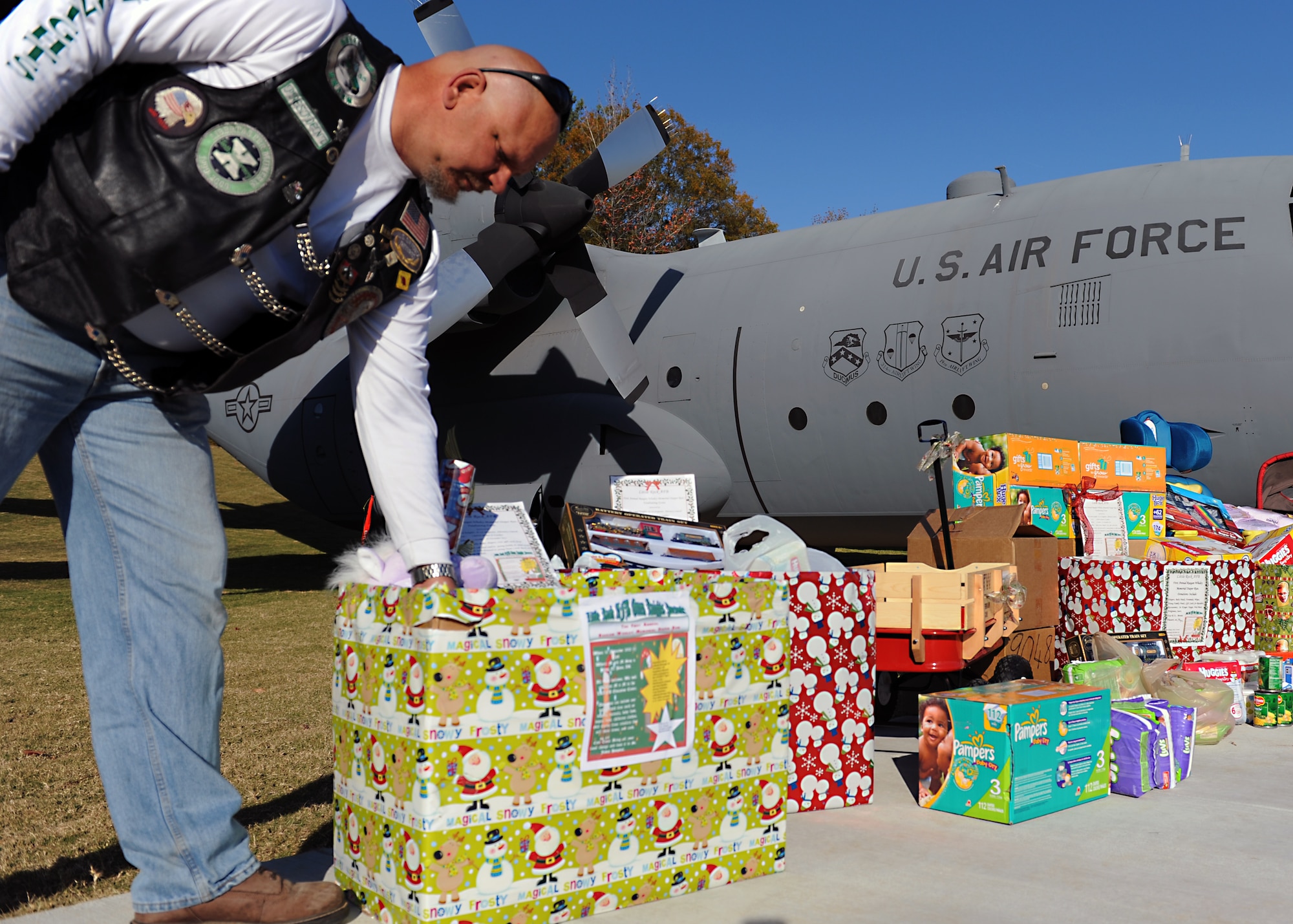 Terry Thomas, a 19th Mission Support Group resource advisor, and a member of the Green Knights, contributes to the donations during the First Annual Raegan Whaley Memorial Diaper Run Nov. 10, 2012, at Little Rock Air Force Base, Ark. The Green Knights are a local motorcycle club, consisting of members of the local and military community. (U.S. Air Force photo by Staff Sgt. Jessica Condit)