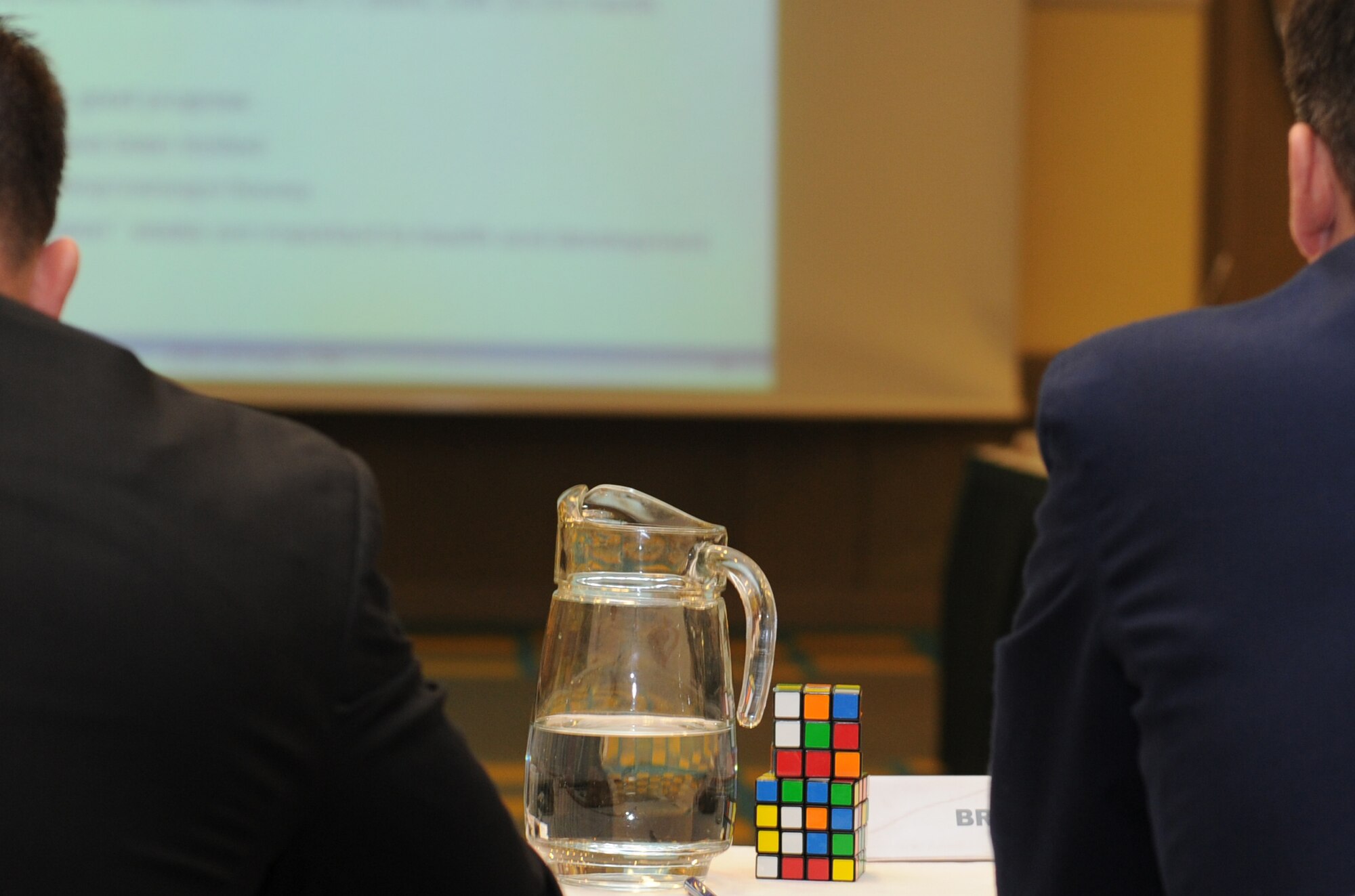 Col. Keith Boone, Heavy Airlift Wing Commander, uses two Rubix cubes to demonstrate the innate complexities of executing the wing mission to members of the Strategic Airlift Capability Steering and Program Boards during a conference Nov. 14, 2012, in Tallinn, Estonia. (U.S. Air Force photo/Capt. Michael Hertzog)