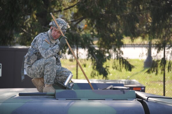 Pfc. William Suarez, 710th Brigade Support Battalion fueler, from Bogata, Columbia, gauges the tanks of a Heavy Expanded Mobility Tactical Truck to determine how much fuel is currently in the tank Nov. 6, 2012, at Joint Base McGuire-Dix-Lakehurst, N.J. Soldiers from the 710th BSB out of Fort Drum, N.Y., worked with Airmen from the 87th Logistics Readiness Squadron Fuels Management Flight, to fill five HEMTTs with fuel to be delivered to regions around New York and New Jersey for Hurricane Sandy relief efforts.  (U.S. Air Force photo/2nd Lt. David J. Murphy)
