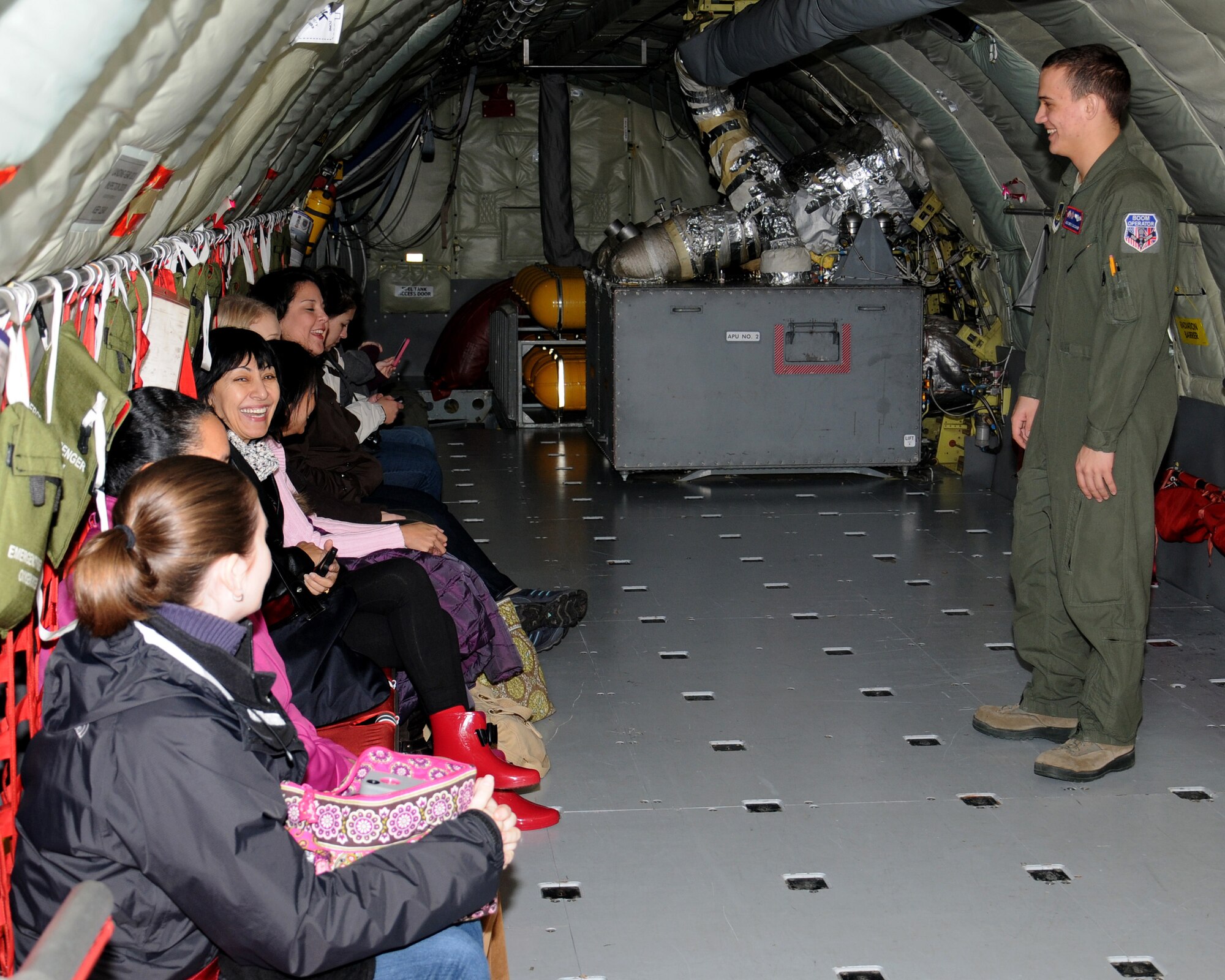 Spouses from the 100th Air Refueling Wing staff agencies listen to a safety briefing from Airman 1st Class Eric Daschner, 351st Air Refueling Squadron boom operator, prior to their KC-135 Stratotanker orientation flight Nov. 14, 2012, at RAF Mildenhall, England. The purpose of the orientation flight is to give spouses more insight to the base’s mission. (U.S. Air Force photo by Gina Randall/Released)