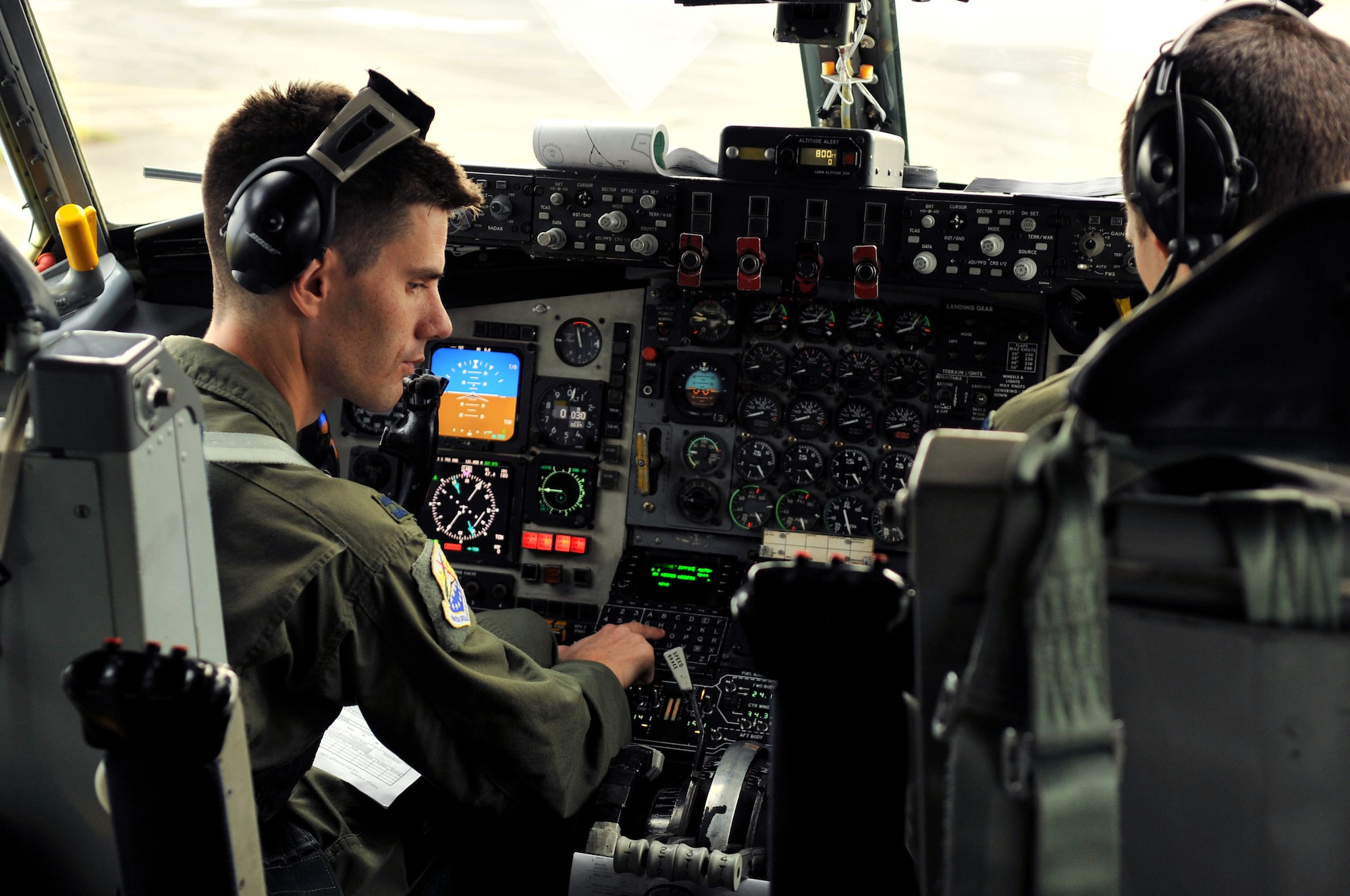 Capt. Justin Gibbons, 100th Operations Group pilot, performs pre-flight checks on board a KC-135 Stratotanker Nov. 14, 2012, at RAF Mildenhall, England. Eight spouses were invited to take part in an orientation flight to gain more insight to the base’s mission. (U.S. Air Force photo by Senior Airman Jerilyn Quintanilla/Released)