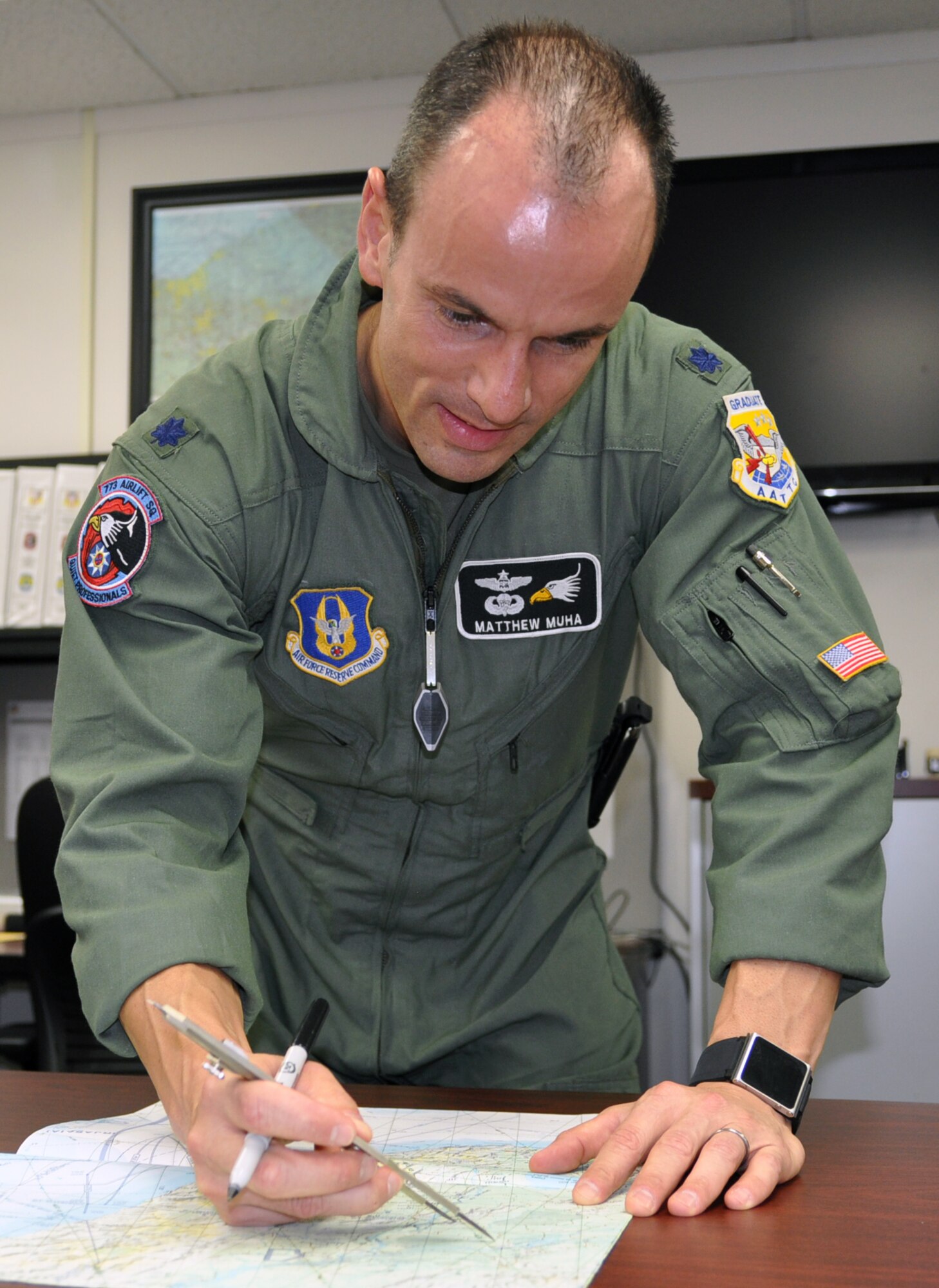 YOUNGSTOWN AIR RESERVE STATION, Ohio – U.S. Air Force Reserve Lt. Col. Matthew Muha, navigator with the 910th Operations Support Squadron, looks over a map at here, during a Unit Training Assembly to determine the route for an upcoming flight. Navigators are also mission planners who help manage time and back up pilots if need be. Released/U.S. Air Force photo by Staff Sgt. Valerie Smock