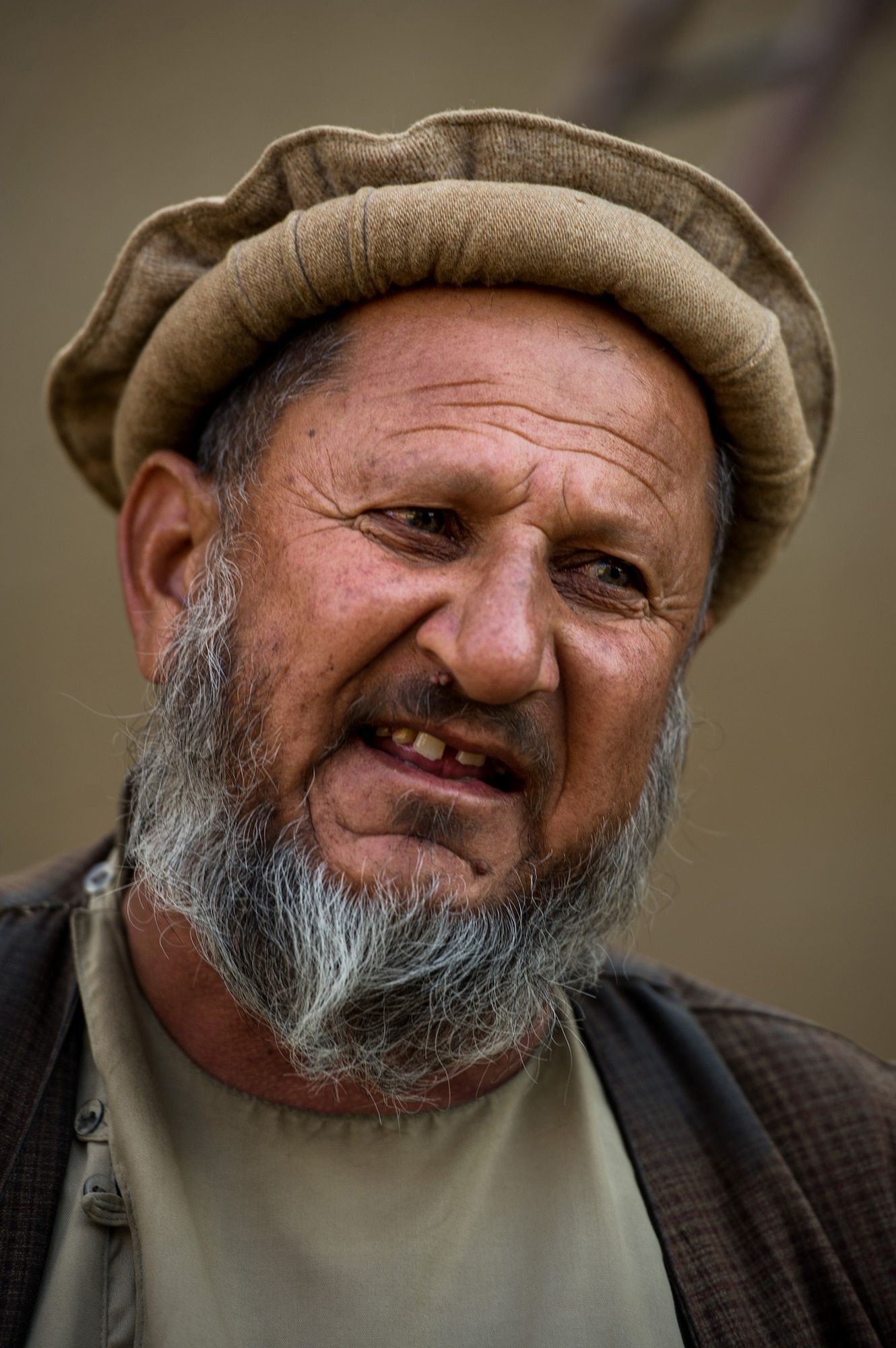 A local Afghan villager talks with U.S. Air Force 455th Expeditionary Security Forces Squadron, Reaper Team, during a village visit Oct. 25, 2012, outside Bagram Airfield, Afghanistan. Reaper teams regularly perform counter-insurgency missions, visiting numerous villages within the Bagram district where they meet local elders and children. These visits help build a good working relationship with the local villagers, along with providing additional safety and security to the area. (U.S. Air Force photo/ Staff Sgt. Jonathan Snyder)(RELEASED)