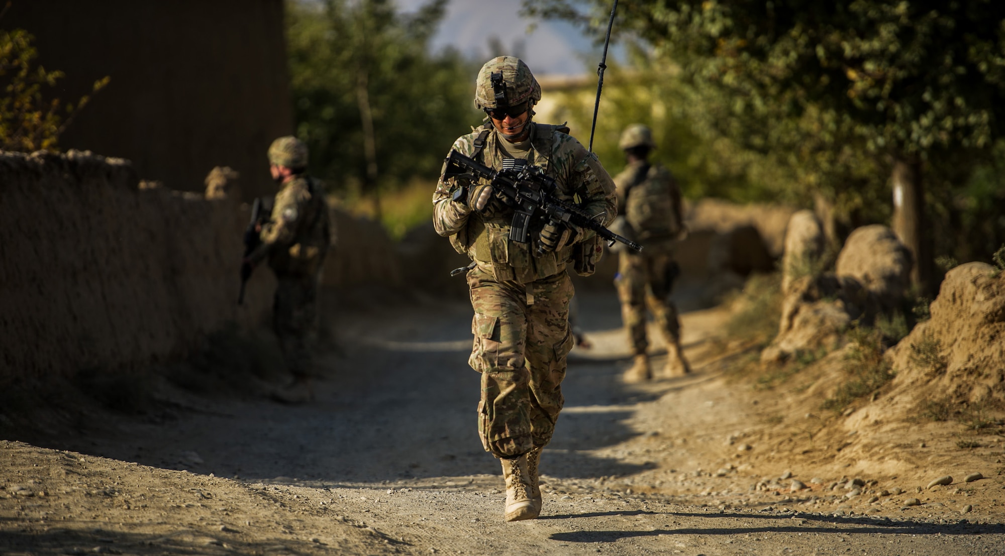 U.S. Air Force Staff Sgt. Flavio Martinez, 455th Expeditionary Security Forces Squadron, Reaper Team, makes his way to a local village Oct. 25, 2012, outside Bagram Airfield, Afghanistan. Reaper teams regularly perform counter-insurgency missions, visiting numerous villages within the Bagram district where they meet local elders and children. These visits help build a good working relationship with the local villagers, along with providing additional safety and security to the area. Martinez hometown is New York, N.Y. (U.S. Air Force photo/ Staff Sgt. Jonathan Snyder)(RELEASED)