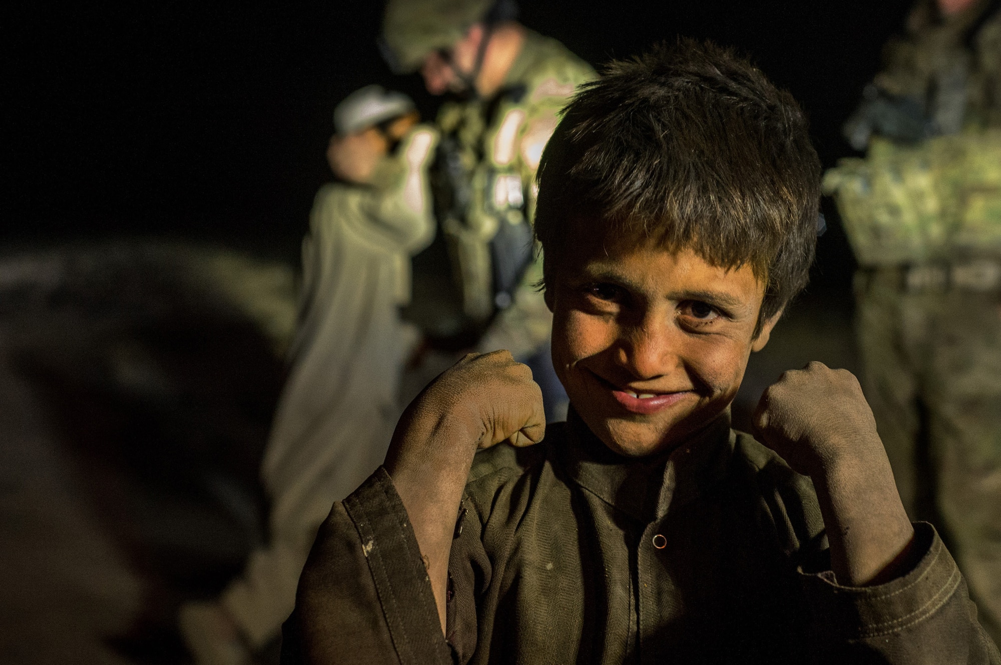 A local Afghan boy greets U.S. Air Force Security Forces Airmen from the 455th Expeditionary Security Forces Squadron, during their patrol Oct. 24, 2012, at outside Bagram Airfield, Afghanistan. 455th ESFS regularly have teams patrol "outside the wire" around the base perimeter looking for suspicious activity and visiting local villages to strengthen working relations with the locals. (U.S. Air Force photo/ Staff Sgt. Jonathan Snyder)(RELEASED)